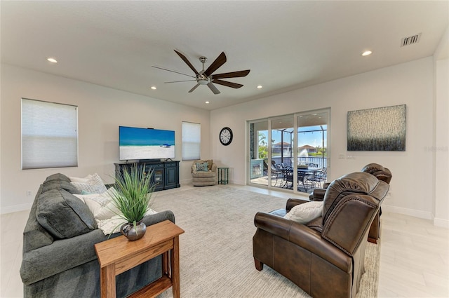 living area featuring baseboards, visible vents, a ceiling fan, and recessed lighting