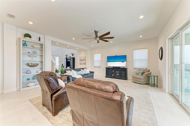 living area with ceiling fan, visible vents, baseboards, and recessed lighting