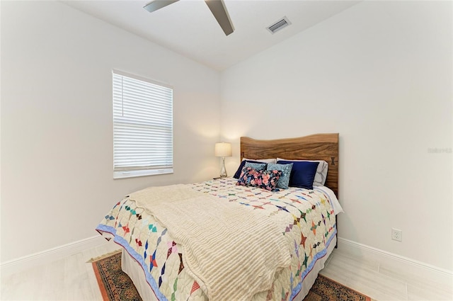 bedroom featuring a ceiling fan, visible vents, and baseboards