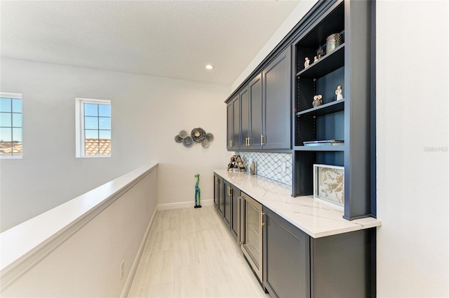 bar featuring recessed lighting, backsplash, and baseboards