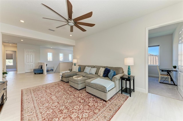 living room with recessed lighting, visible vents, ceiling fan, and baseboards