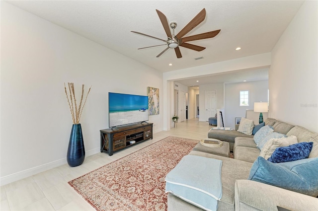 living area featuring recessed lighting, visible vents, ceiling fan, and baseboards