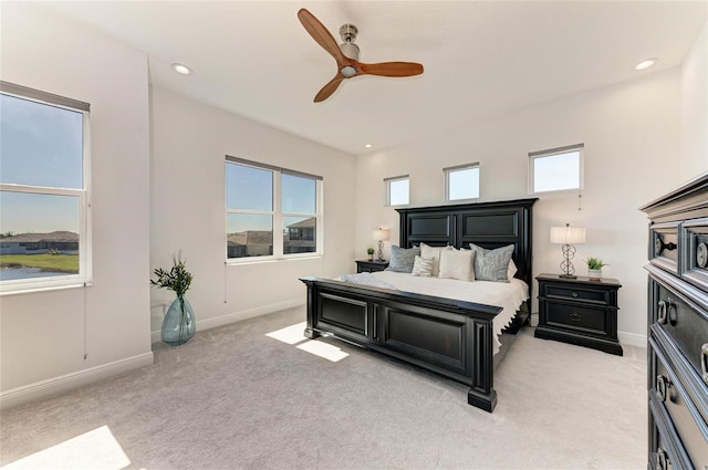 bedroom with baseboards, recessed lighting, a ceiling fan, and light colored carpet