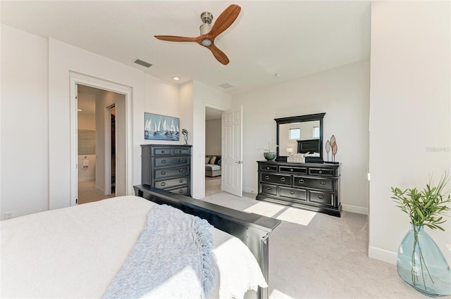 bedroom with a ceiling fan, light colored carpet, connected bathroom, and baseboards