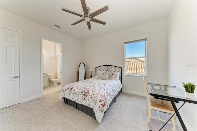 bedroom with visible vents, a ceiling fan, light carpet, connected bathroom, and baseboards