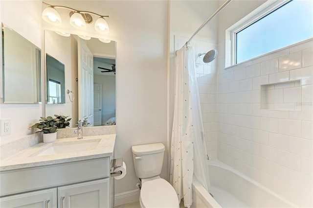 ensuite bathroom featuring connected bathroom, toilet, a ceiling fan, vanity, and shower / bath combination with curtain