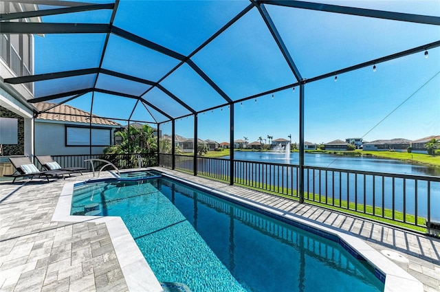 view of pool featuring a patio, a water view, a lanai, and a pool with connected hot tub