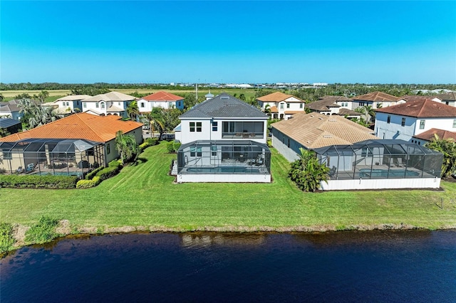 birds eye view of property featuring a water view and a residential view