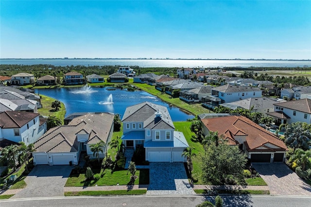 drone / aerial view with a water view and a residential view