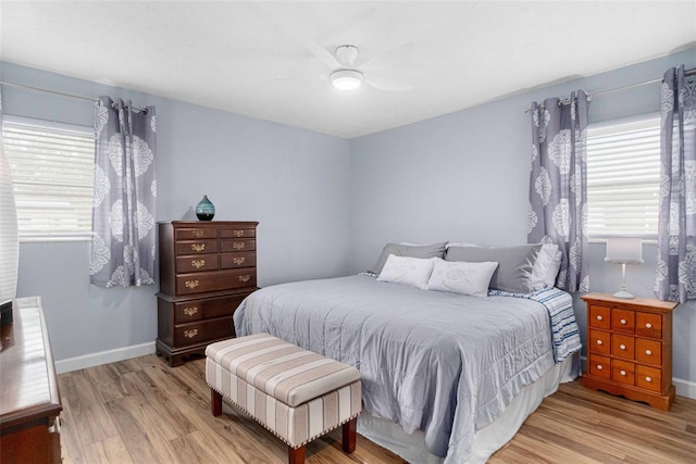 bedroom featuring light wood-type flooring, ceiling fan, and baseboards