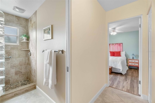 ensuite bathroom with visible vents, connected bathroom, tile patterned flooring, tiled shower, and baseboards