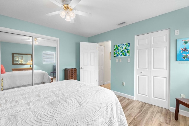 bedroom featuring ceiling fan, visible vents, baseboards, a closet, and light wood-type flooring