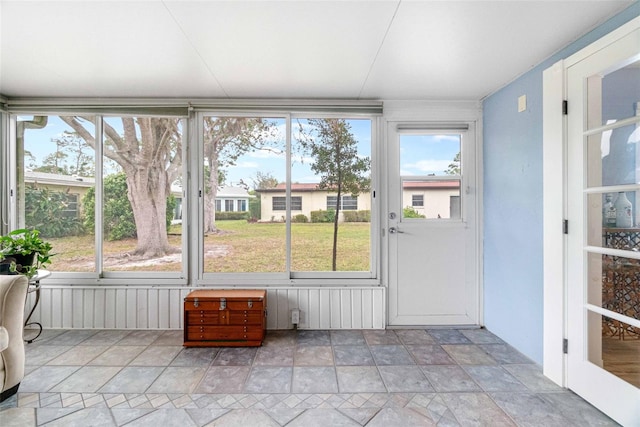 unfurnished sunroom with plenty of natural light