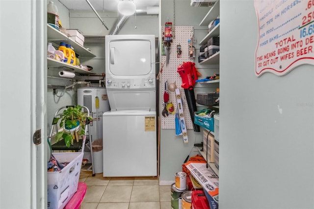 clothes washing area featuring laundry area, water heater, stacked washer / dryer, and tile patterned floors