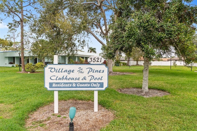 community / neighborhood sign with a yard