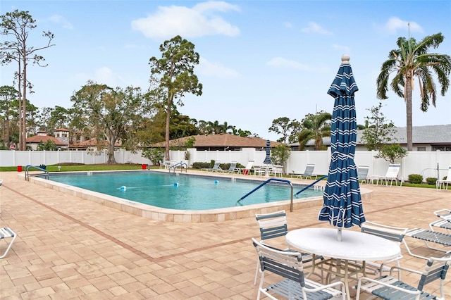 community pool featuring a patio area and fence