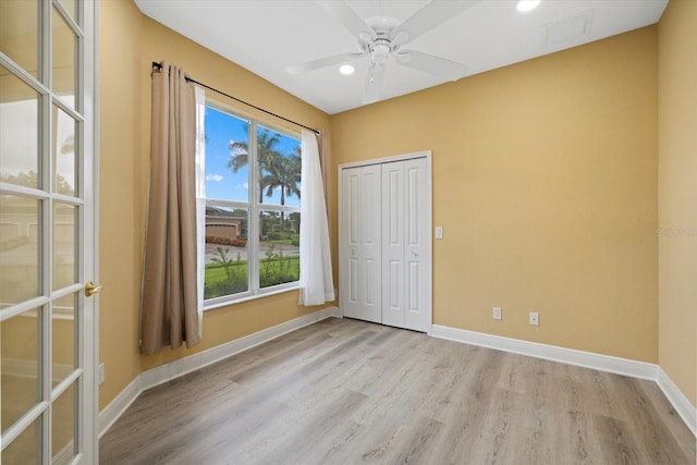 unfurnished bedroom with recessed lighting, a closet, baseboards, and wood finished floors