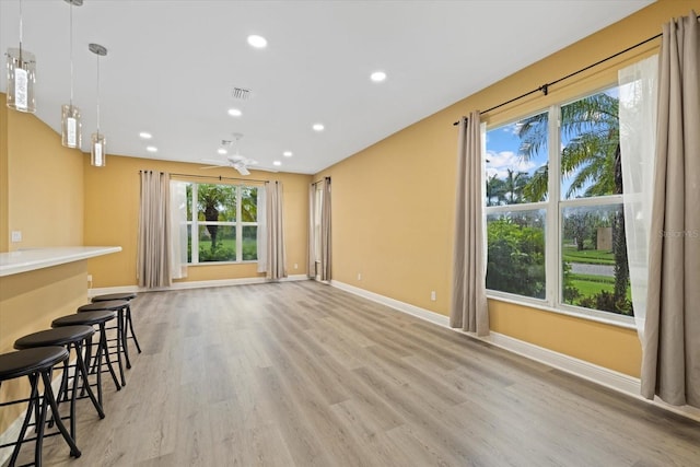 unfurnished living room with visible vents, baseboards, ceiling fan, light wood-style floors, and recessed lighting