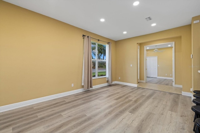 unfurnished room with baseboards, recessed lighting, visible vents, and light wood-style floors