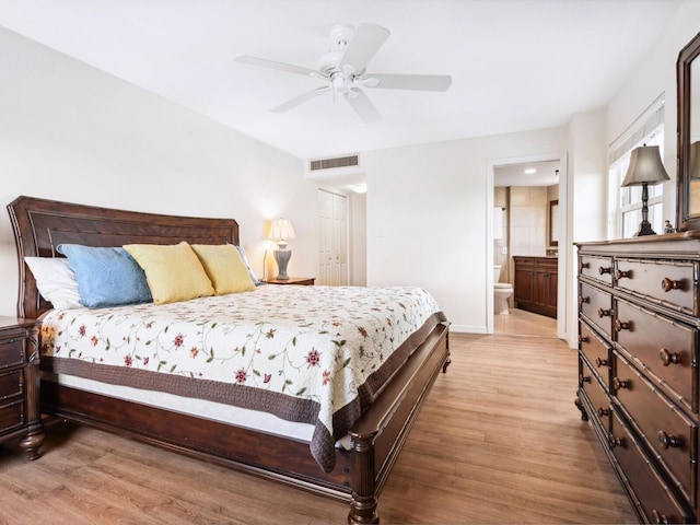 bedroom featuring visible vents, light wood-style flooring, connected bathroom, ceiling fan, and baseboards