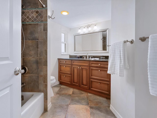 full bath featuring washtub / shower combination, toilet, vanity, and baseboards