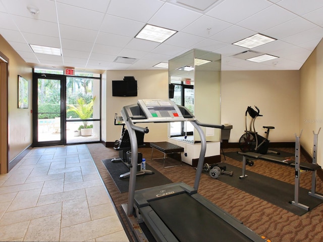 interior space featuring plenty of natural light, visible vents, baseboards, and a drop ceiling