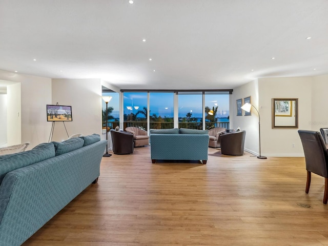 living area with recessed lighting and light wood finished floors