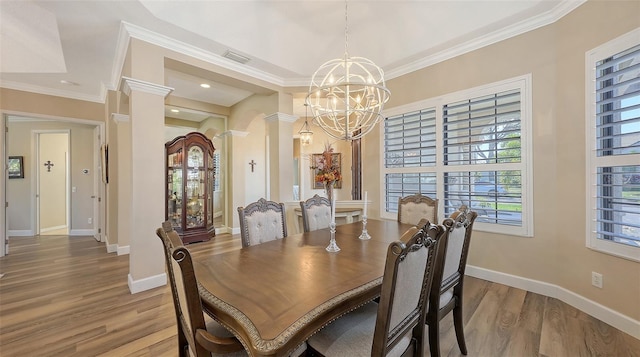 6621 The Masters Ave, Lakewood Ranch, FL 34202 - dining area with a chandelier, light wood finished floors, ornamental molding, ornate columns, and baseboards