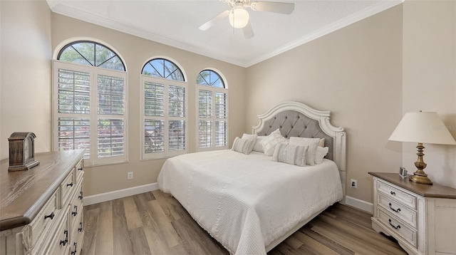 6621 The Masters Ave, Lakewood Ranch, FL 34202 - bedroom with wood finished floors, ornamental molding, baseboards, and ceiling fan