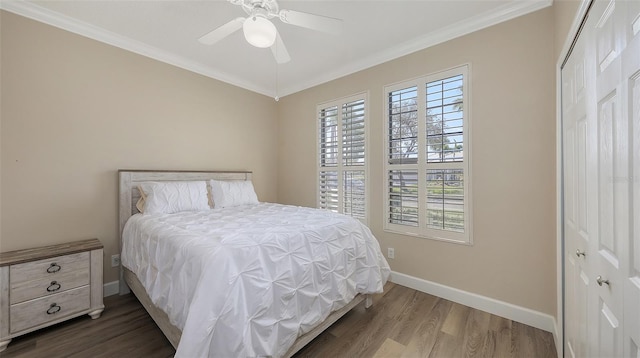 6621 The Masters Ave, Lakewood Ranch, FL 34202 - bedroom with ornamental molding, baseboards, wood finished floors, a closet, and ceiling fan