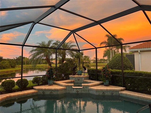 6621 The Masters Ave, Lakewood Ranch, FL 34202 - pool at dusk with a jacuzzi, glass enclosure, and an outdoor pool
