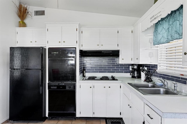 2564 Wood St, Sarasota, FL 34237 - kitchen with under cabinet range hood, a sink, white cabinetry, light countertops, and black appliances