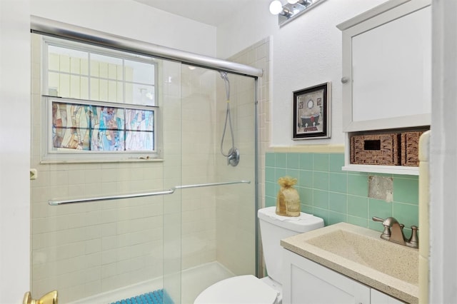2564 Wood St, Sarasota, FL 34237 - bathroom featuring tile walls, toilet, a stall shower, wainscoting, and vanity