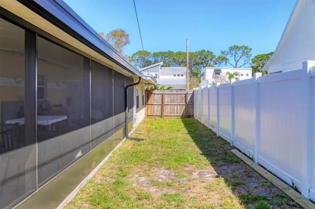 2564 Wood St, Sarasota, FL 34237 - view of yard with a sunroom and a fenced backyard