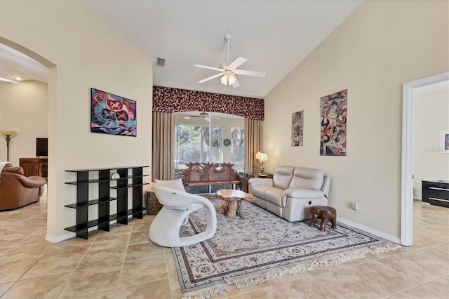 living area featuring arched walkways, light tile patterned floors, visible vents, a ceiling fan, and high vaulted ceiling