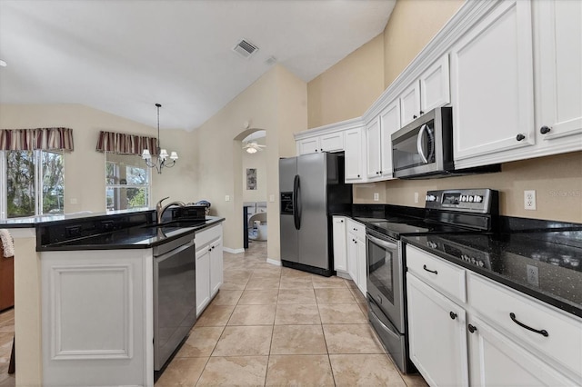 kitchen featuring light tile patterned flooring, stainless steel appliances, a sink, white cabinetry, and vaulted ceiling