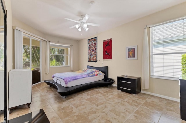 bedroom with ceiling fan and baseboards