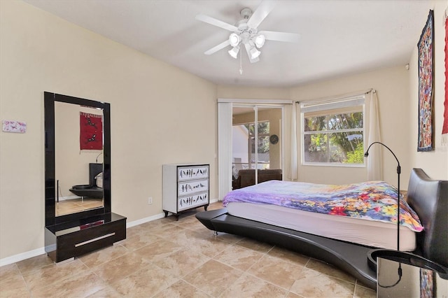 bedroom with a ceiling fan and baseboards