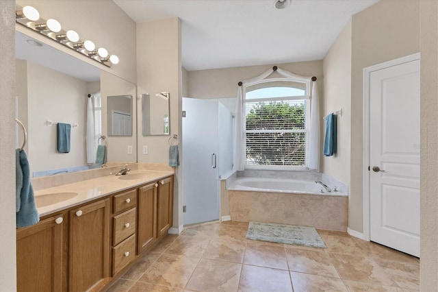 bathroom featuring a garden tub, tile patterned flooring, a sink, double vanity, and walk in shower