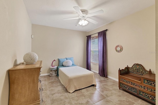 bedroom featuring a ceiling fan and baseboards