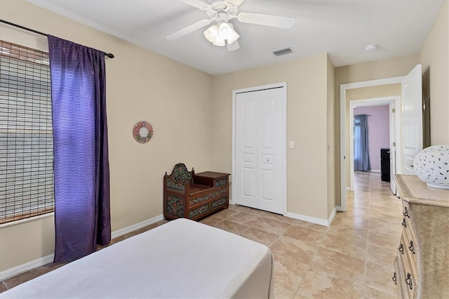 bedroom featuring a ceiling fan, a closet, visible vents, and baseboards