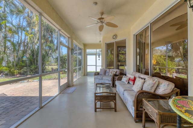 sunroom / solarium featuring ceiling fan