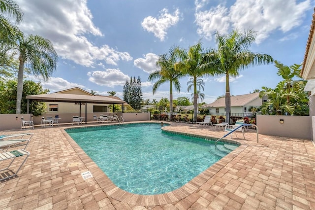 pool featuring a patio area and fence