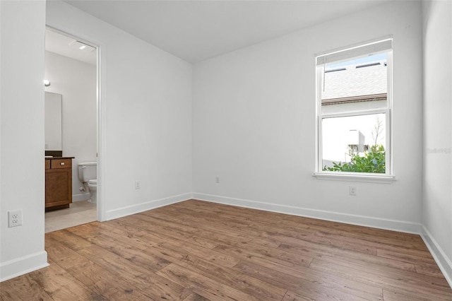 empty room with light wood-style floors and baseboards