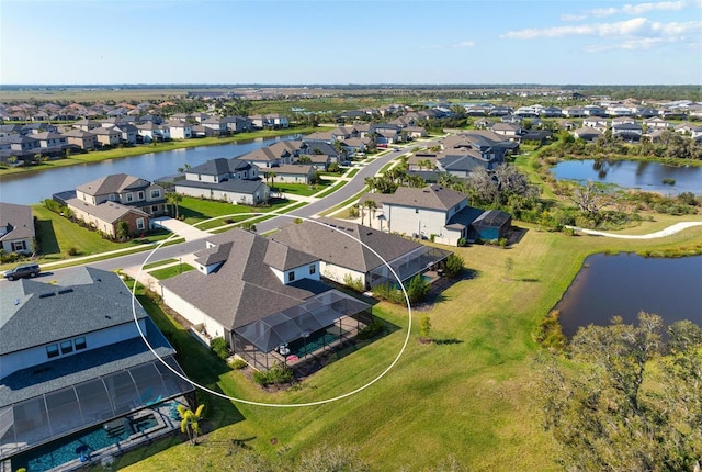 birds eye view of property featuring a water view and a residential view