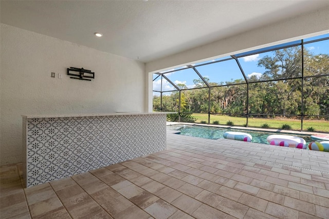 pool featuring a lanai and a patio area