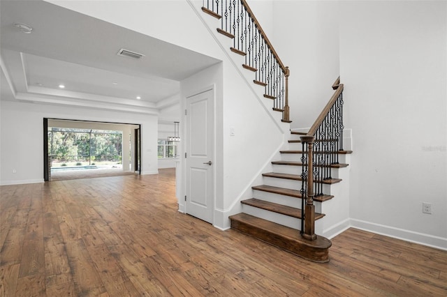 stairway featuring hardwood / wood-style flooring and baseboards