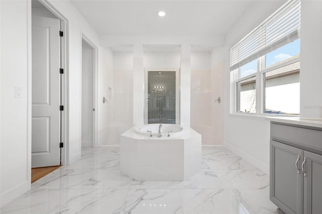 bathroom featuring marble finish floor, a garden tub, baseboards, and a walk in shower