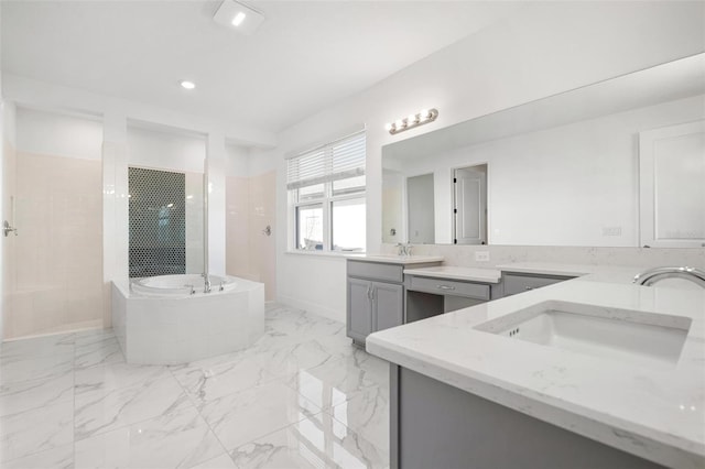 bathroom with a walk in shower, marble finish floor, a sink, and a bath