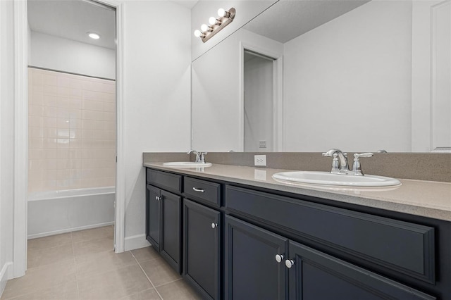 full bath featuring tile patterned floors, a sink, baseboards, and double vanity